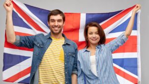 Happy Husband and wife holding british flag