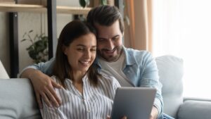 Husband and wife preparing spouse visa on ipad