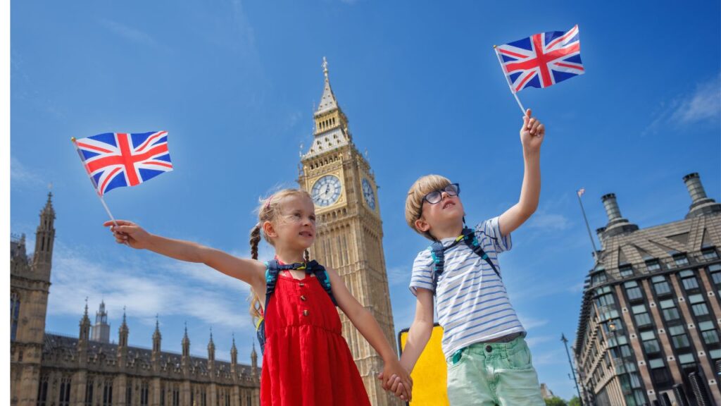 Two children in London holding british flags