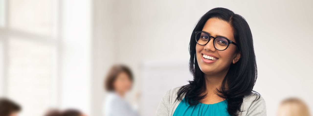 do-i-need-witnesses-for-my-indian-power-of-attorney-hero A smiling professional woman, illustrating witness requirements for an Indian power of attorney