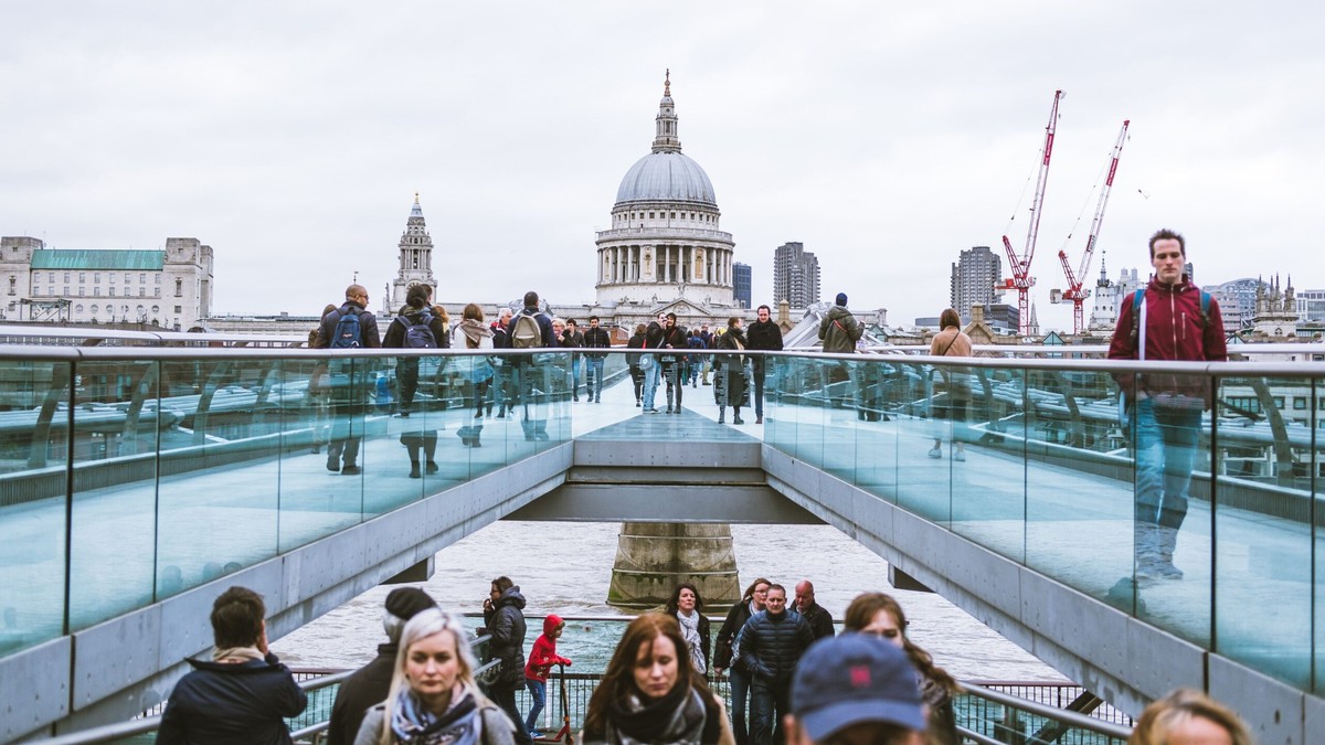 Home Office reduce migration Crowds crossing the Millennium Bridge towards St Paul's Cathedral in London, illustrating the Home Office plan to cut net migration