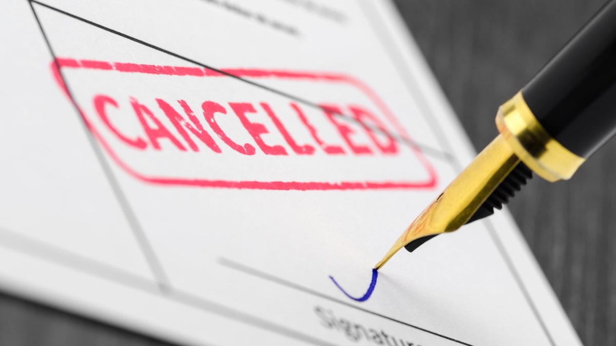 Revocation of Indian Power of Attorney Red cancelled stamp on a document beside a fountain pen at the signature line, representing revoking an Indian Power of Attorney