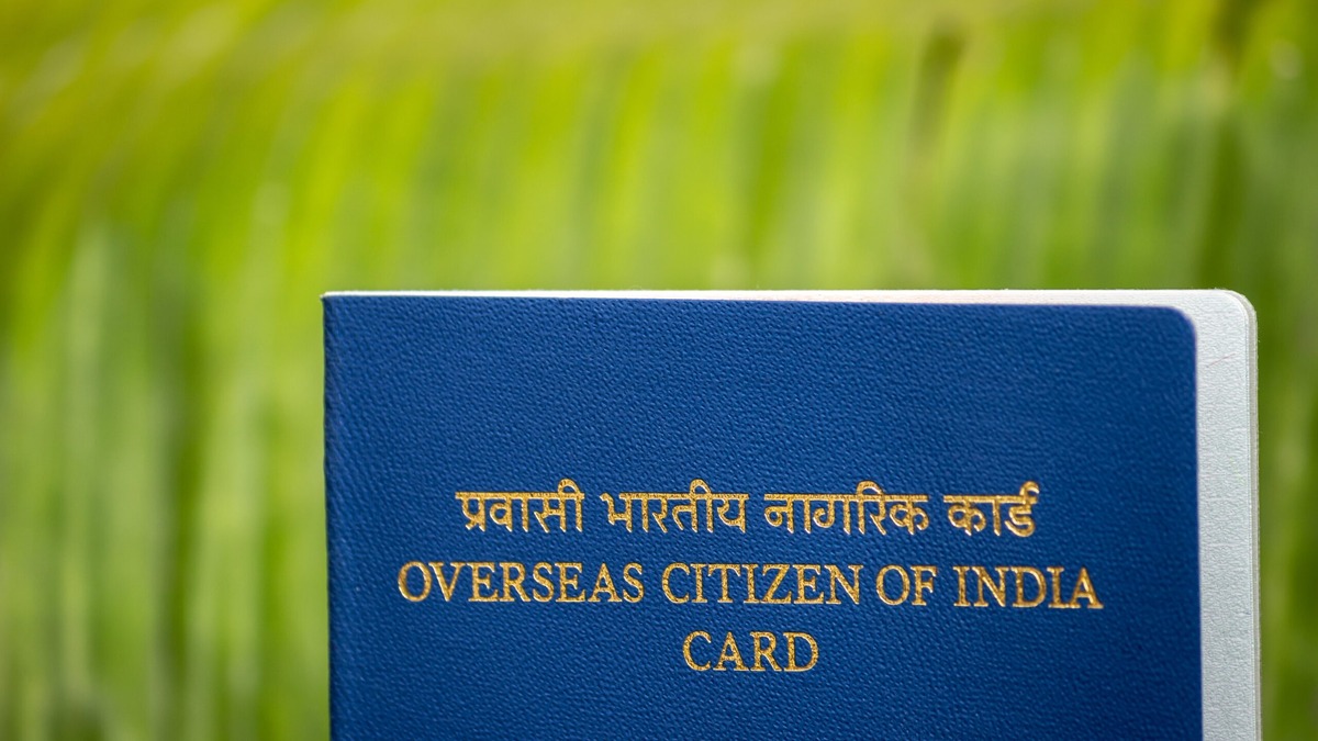 OCI Card FAQs Blue Overseas Citizen of India card in Hindi and English against green grass, illustrating common questions about OCI applications