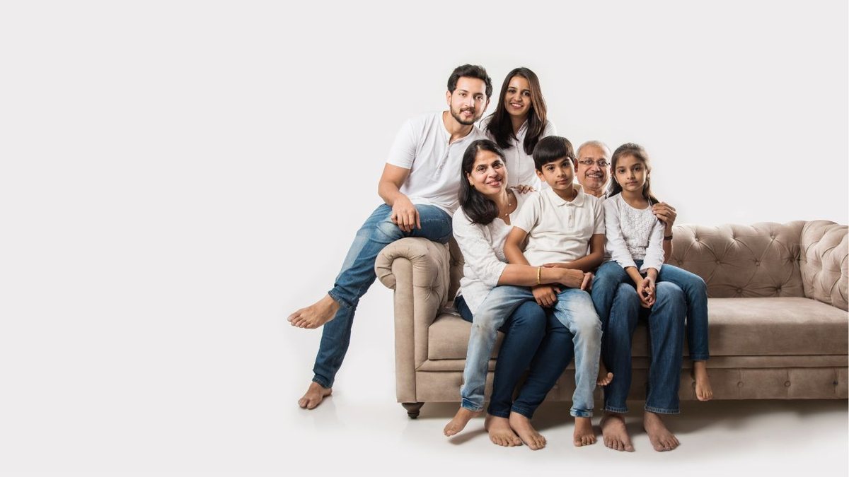 General Power of Attorney for India Three-generation Indian family sitting together on a sofa, illustrating a general Power of Attorney for NRIs managing affairs in India